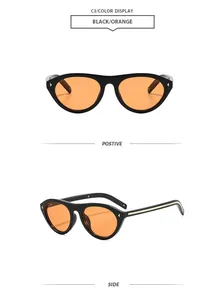 Vues de face et de profil de lunettes de soleil vintage œil-de-chat noires à verres oranges.