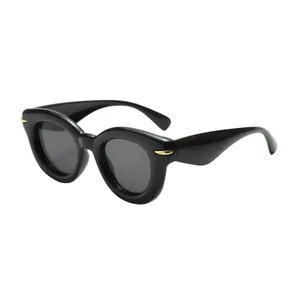 Trendy round bubble thick frame sunglasses with sleek black finish and gold accents.