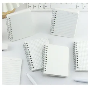 Mini portable spiral notebooks with frosted PP covers shown in a workspace setting