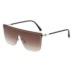 Occhiali da sole shield oversize senza montatura con lenti sfumate marroni e aste argento.