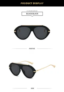 Detailed front and side views of black oversized aviator sunglasses with gold accents.