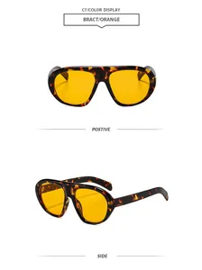 Λεπτομερής προβολή γυαλιών ηλίου aviator με σκελετό ταρταρούγα και πορτοκαλί φακούς.
