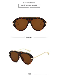 Detailed view of leopard aviator sunglasses with dark brown lenses and gold frame