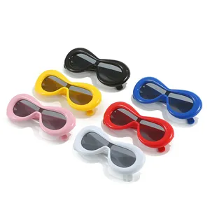 Group of avant-garde chunky sunglasses in vibrant candy colors with one-piece lenses.