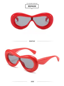 Detail of avant-garde red chunky frame sunglasses shown in front and side views.