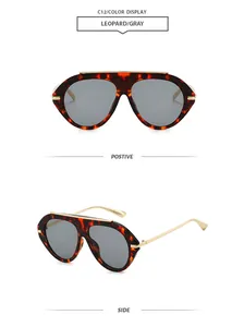 Detail view of leopard print aviator sunglasses with gray lenses and gold accents