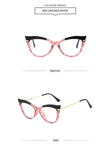 Lunettes de soleil œil de chat oversize avec monture rouge à motifs et branches.