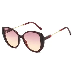 Oversized burgundy sunglasses featuring pink gradient lenses and elegant gold temples