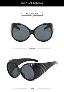 Detailed views showing front and side of retro modern black oval oversized sunglasses.