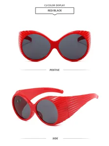 Retro oversized red sunglasses with dark lenses and ribbed frame detail