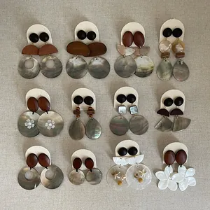 Detailed collection of twelve retro-style earrings featuring wood and shell textures.