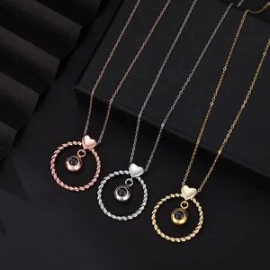 Detailed view of heart circle twisted projection necklaces in rose gold, silver, and gold.
