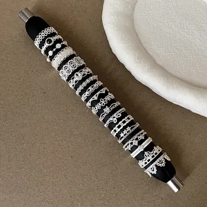 Macro view of French style silver lace hollow ring collection on a black leather display mandrel