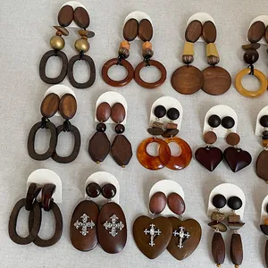 Detailed view of various vintage wooden geometric earrings with heart and circle shapes