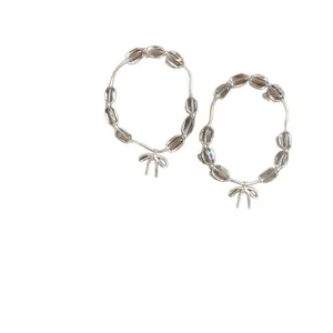 Elegante bracciale di perle trasparenti con fiocco e filo d'argento per la moda donna