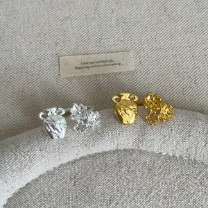 Detailed close-up shot of vintage gold and silver textured jar flower metal rings