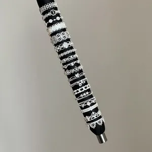 Detailed collection of silver lace hollow metal rings for women displayed on a sleek black rod