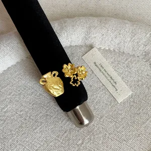 Macro close-up detail of a French style gold ring featuring flower and vase textures