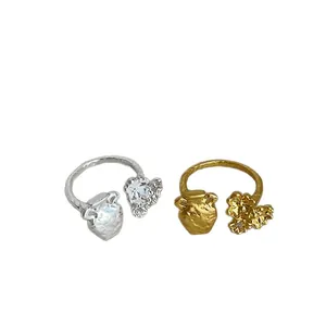 French style metal rings with textured pottery jar and floral design in gold and silver