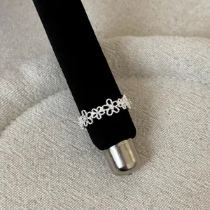 Detailed macro view of elegant French style lace openwork silver ring on display