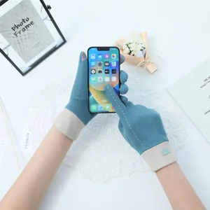 Detail of women's warm Dralon gloves showing touchscreen functionality on a smartphone