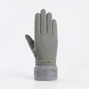 Close-up of grey winter thermal full-finger glove with faux fur cuff and fashion detail