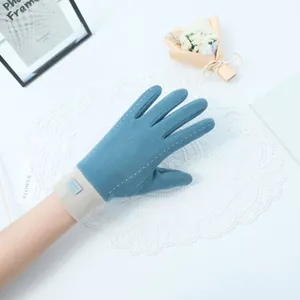 Close-up of blue warm winter gloves for women with stitching detail on a white background.