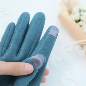 Close-up detail of thermal gloves with touch-screen compatible fingertips and soft fabric