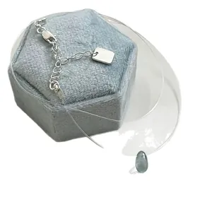 Elegant minimalist invisible fishing line necklace featuring a blue teardrop stone pendant