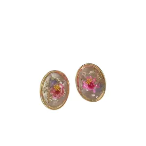Elegant vintage oval stud earrings featuring transparent resin and delicate pink dried flowers