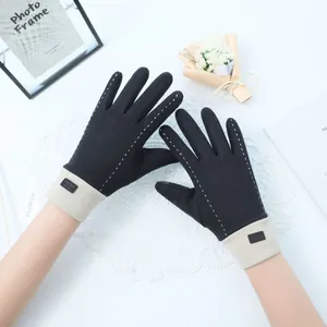 Close-up view of elegant black thermal gloves featuring white dashed line stitching.