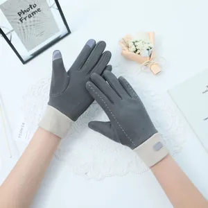 Close-up detail of grey touchscreen gloves with white stitching and beige cuffs.