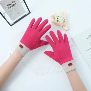 Close-up of pink Dralon gloves with white stitching and warm ribbed cuffs.
