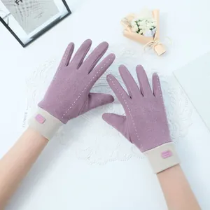 Detail view of purple thermal gloves with elegant white stitching and touch-screen compatibility