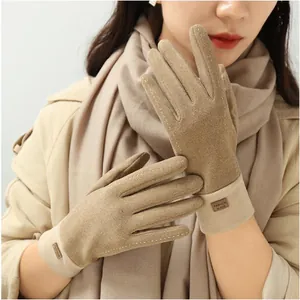 Close-up of warm winter gloves with touchscreen fingertips and decorative stitching