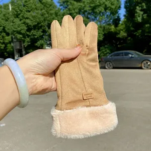 Detail view of warm suede gloves with plush faux fur cuff for winter