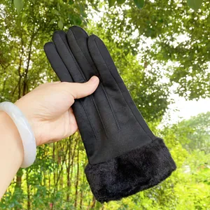 Detailed view of black faux suede winter gloves with thick faux fur trim on the wrist.