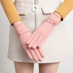 Detail shot of pink thermal winter gloves with scalloped edges and decorative button