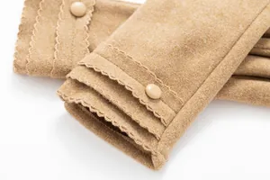 Close-up of warm winter gloves featuring scalloped edges and decorative button