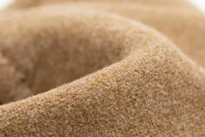 Macro detail of soft camel rabbit fur velvet fabric texture for warm winter outdoor gloves