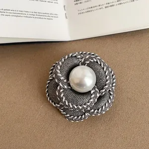 Exquisite camellia brooch featuring grey fabric petals and a central high-lustre pearl detail
