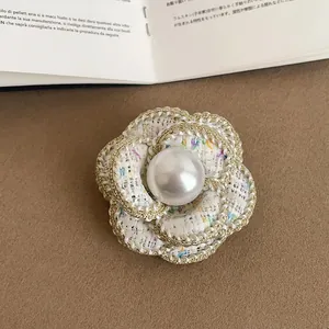 Elegant tweed camellia brooch with faux pearl detail for socialite style.