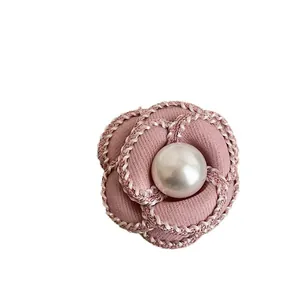 Elegant pink fabric camellia brooch with a large pearl center for high-end fashion