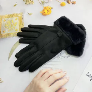 Detail of black suede winter gloves for women featuring soft faux fur cuffs and elegant design.