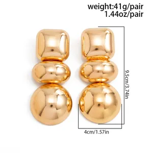 Oversized gold geometric earrings with mirror finish, showing size and weight details