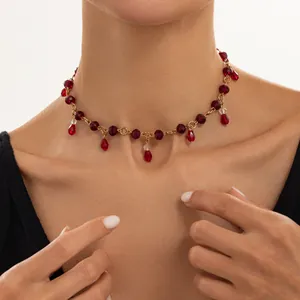 Close-up of vintage dark red crystal beaded necklace with teardrop tassels