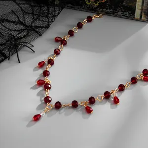 Close-up of gothic red crystal beaded necklace with water drop tassel pendant