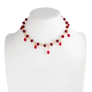 Macro view of vintage red crystal beaded necklace with elegant water-drop tassels