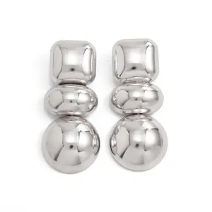 Detail view of silver geometric mirrored earrings with stacked square and sphere shapes