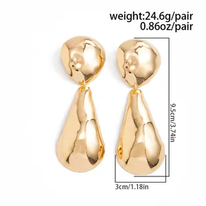 Close-up detail of oversized gold hammered water drop earrings showing size dimensions